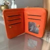 کیف پول نارنجی کوچک با چندین بخش و جزئیات طلایی برند ilknurbutik - 883937990