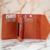 کیف پول شیک نارنجی با چرم نرم زنانه و دکمه و زیپ، مناسب برای کارت‌ها و لوازم جانبی. برند Genel Markalar - 753555150