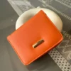 کیف پول نارنجی کوچک با چندین بخش و جزئیات طلایی برند ilknurbutik - 883937990