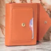 کیف پول شیک نارنجی با چرم نرم زنانه و دکمه و زیپ، مناسب برای کارت‌ها و لوازم جانبی. برند Genel Markalar - 753555150